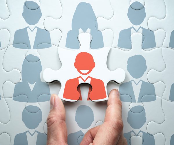 Selecting leader and building team. Business leadership concept.
Connecting last jigsaw puzzle piece.